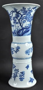 A FINE 17TH CENTURY CHINESE BLUE AND WHITE GU SHAPED: A FINE 17TH CENTURY CHINESE BLUE AND WHITE GU SHAPED BEAKER VASE Kangxi, bearing Xuande marks to base, exceptionally painted with a landscape of flowering rock and birds in flight. 16. 5ins high.