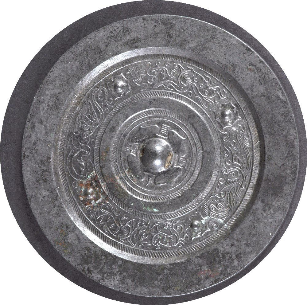 A CHINESE QING DYNASTY SILVERED CIRCULAR BRONZE HAND: A CHINESE QING DYNASTY SILVERED CIRCULAR BRONZE HAND MIRROR Archaic style, decorated with beasts and vines. 6.5ins diameter.