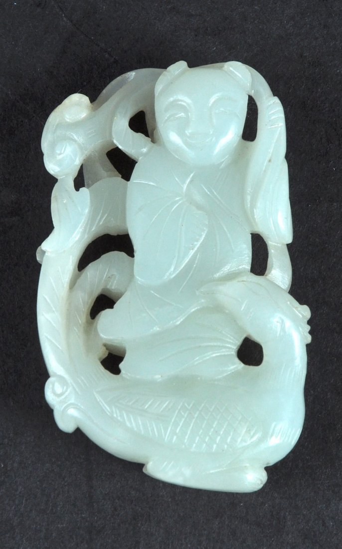 AN EARLY 20TH CENTURY CHINESE CARVED WHITE JADE FIGURE: AN EARLY 20TH CENTURY CHINESE CARVED WHITE JADE FIGURE OF A BOY modelled standing upon a bird. 2.25ins high.