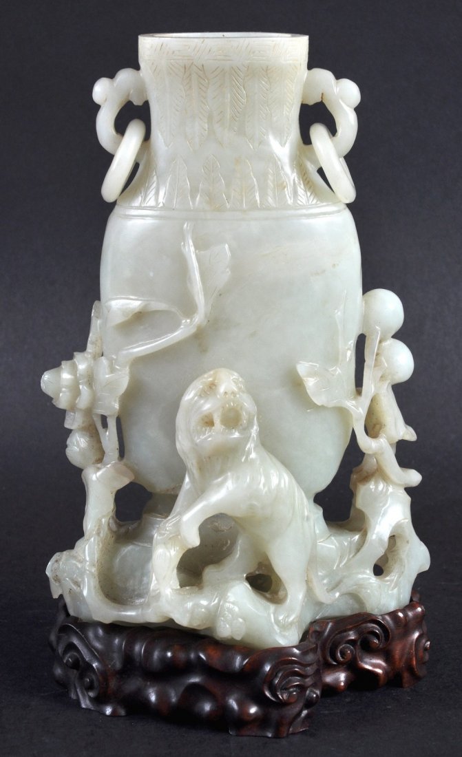 A GOOD CHINESE QING DYNASTY CARVED GREEN JADE VASE: A GOOD CHINESE QING DYNASTY CARVED GREEN JADE VASE formed with a hound standing upon a naturalistic base. Vase 6.75ins high.