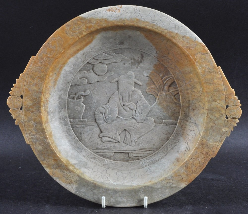 A LATE 19TH CENTURY CHINESE CARVED SOAPSTONE DISH: A LATE 19TH CENTURY CHINESE CARVED SOAPSTONE DISH carved with a scholar within an interior. 11ins diameter.