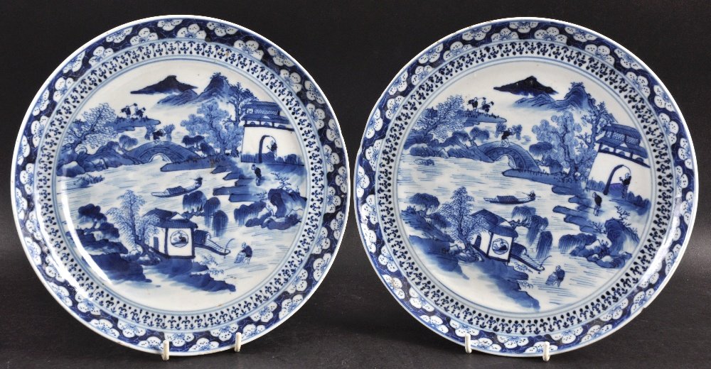 A PAIR OF MID 19TH CENTURY CHINESE BLUE AND WHITE: A PAIR OF MID 19TH CENTURY CHINESE BLUE AND WHITE PLATES painted with landscapes. 9.25ins diameter.