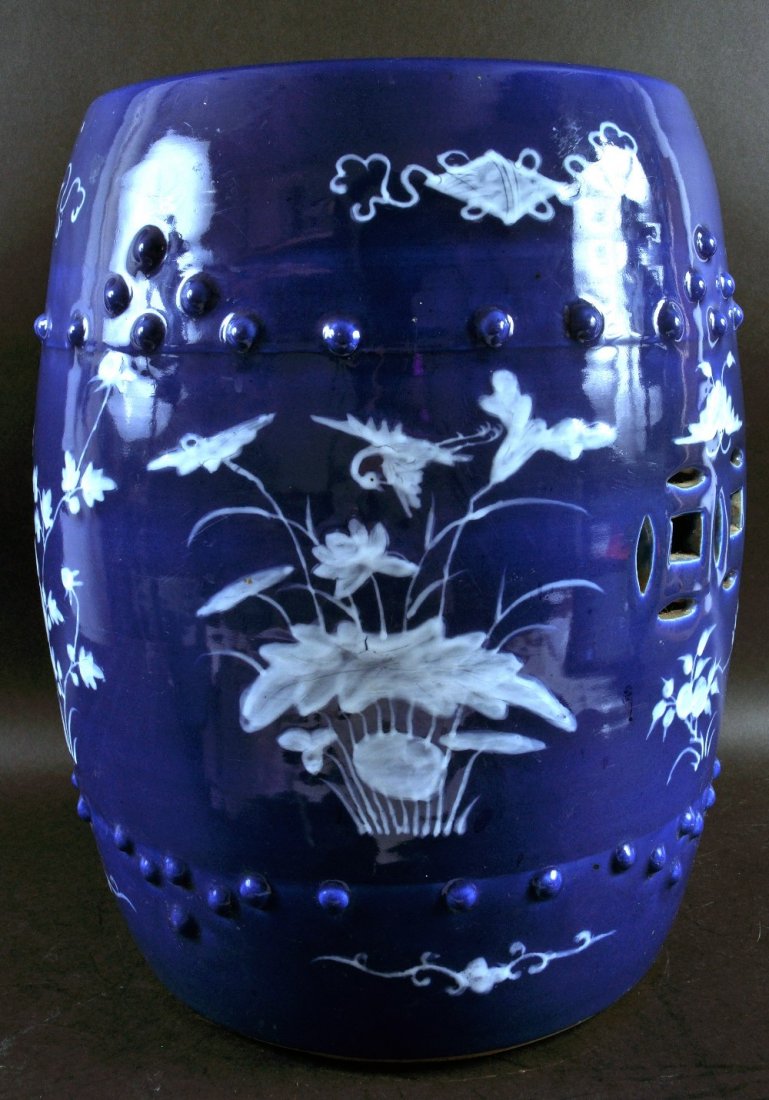 A 19TH CENTURY CHINESE BLUE GROUND PORCELAIN GARDEN: A 19TH CENTURY CHINESE BLUE GROUND PORCELAIN GARDEN SEAT, with white slip decoration, 18in high.