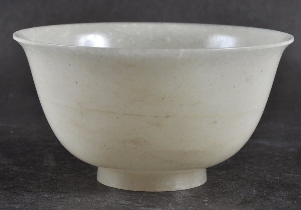 A 20TH CENTURY WHITE JADE BOWL, with mottled: A 20TH CENTURY WHITE JADE BOWL, with mottled inclusions, 3.8in diameter.