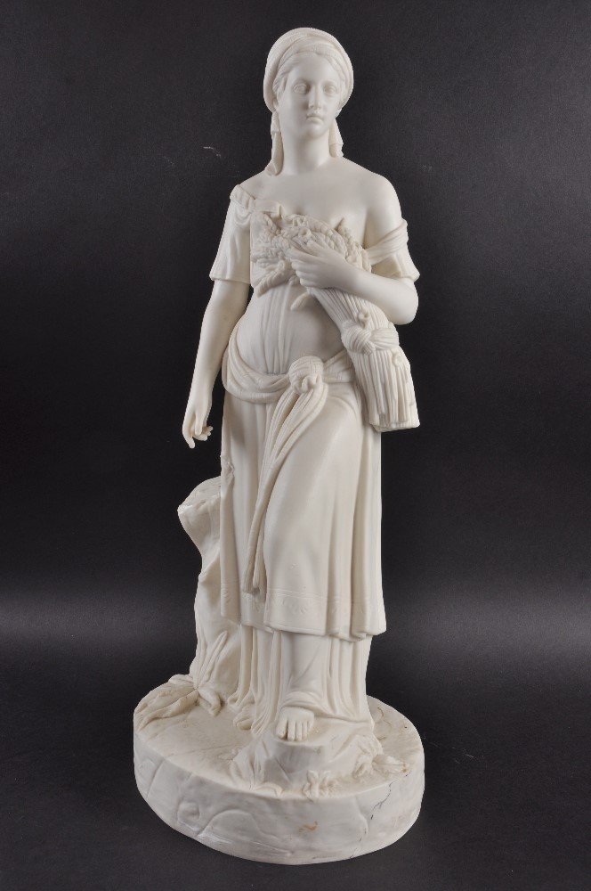 A WHITE PARIAN GROUP OF A YOUNG GIRL carrying a sheath: A WHITE PARIAN GROUP OF A YOUNG GIRL carrying a sheath of corn on an oval base. 21.5ins high. £100-150.