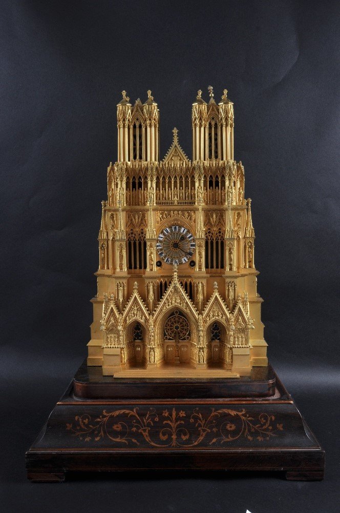 A SUPERB 19TH CENTURY FRENCH “REIMS” CATHEDRAL CLOCK by: A SUPERB 19TH CENTURY FRENCH “REIMS” CATHEDRAL CLOCK by CHILLY FRERES in an ormolu case with black and white Roman numerals striking a single bell. 18.5ins high, stands on a rosewood inlaid base.