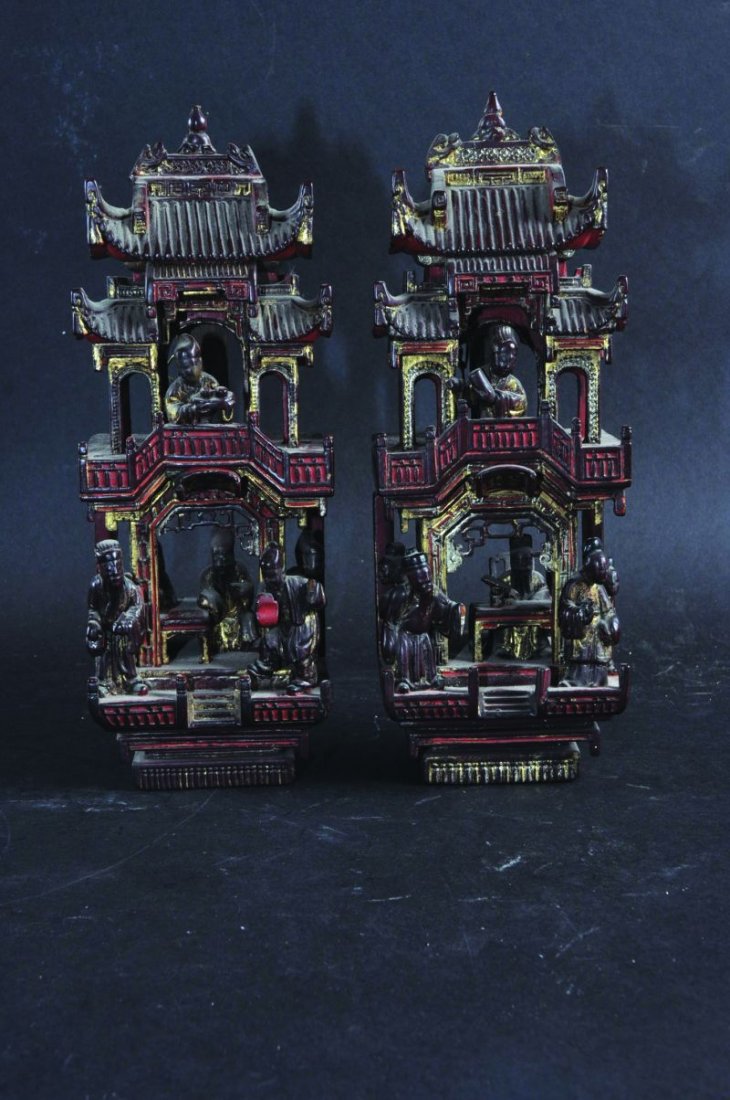 A PAIR OF 19TH CENTURY CHINESE GILDED AND LACQUERED: A PAIR OF 19TH CENTURY CHINESE GILDED AND LACQUERED WOOD CARVINGS, elaborately rendered with figures in pagoda settings, 10.8in high.
