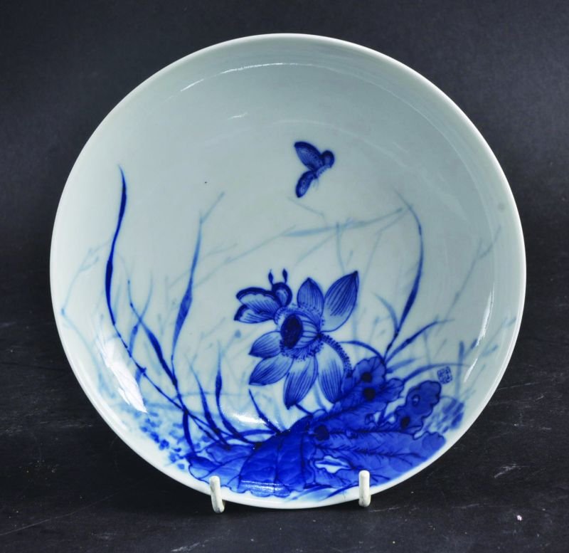 A CHINESE BLUE & WHITE PORCELAIN SAUCER DISH, painted: A CHINESE BLUE & WHITE PORCELAIN SAUCER DISH, painted with a butterfly hovering above a lotus flower, the base with a seal mark, 6.8in diameter.