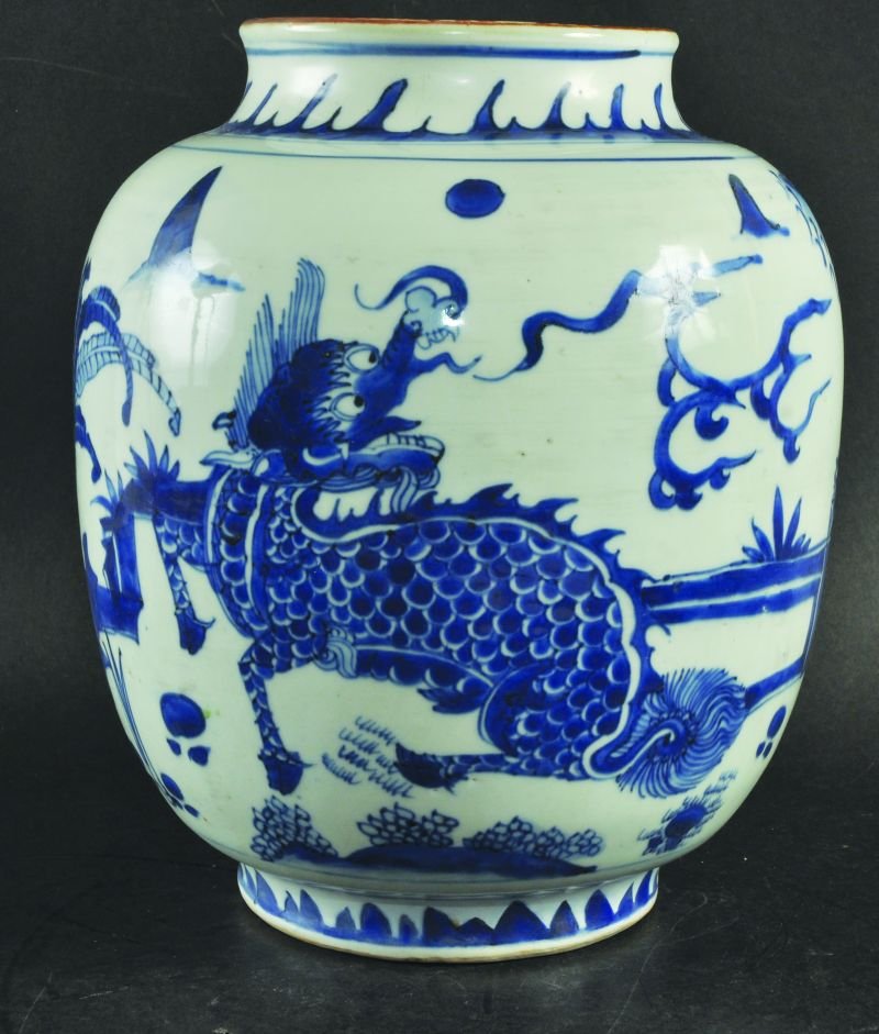A GOOD 17TH CENTURY CHINESE TRANSITIONAL PERIOD BLUE &: A GOOD 17TH CENTURY CHINESE TRANSITIONAL PERIOD BLUE & WHITE PORCELAIN JAR, the sides of the ovoid body painted with a qilin & phoenix beneath flame scrolls in a continuous fenced garden setting, the 