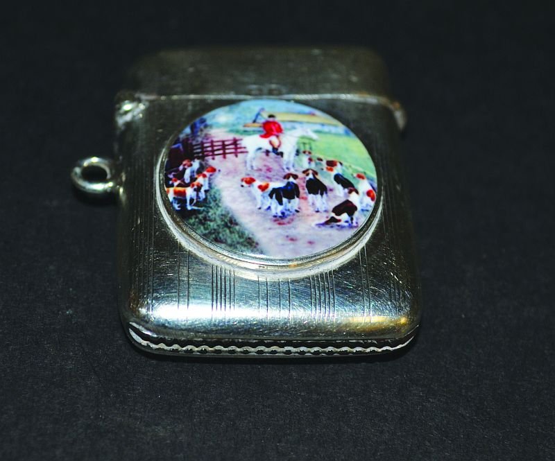 A SILVER VESTA, Birmingham 1919, the front with a: A SILVER VESTA, Birmingham 1919, the front with a circular plaque of a fox hunting scene.