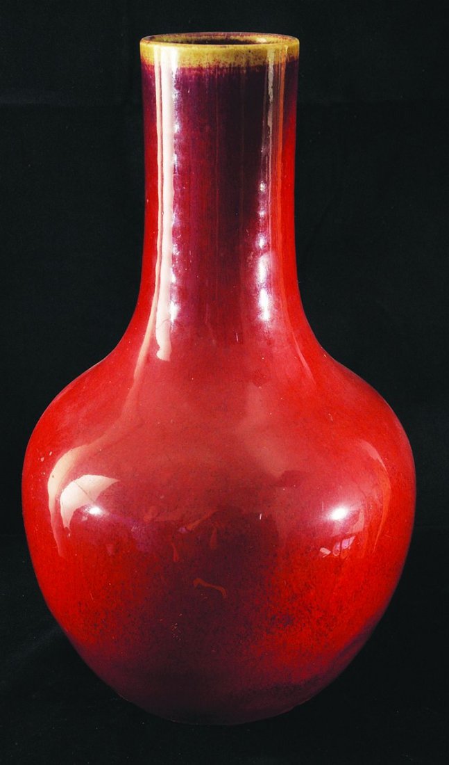 A GOOD 18TH/19TH CENTURY CHINESE SANG-DE-BOEUF: A GOOD 18TH/19TH CENTURY CHINESE SANG-DE-BOEUF PORCELAIN BOTTLE VASE, the glaze turning to a purplish colour on the neck and thinning to a pale beige tone at the rim, 12.25in high. £500-700
