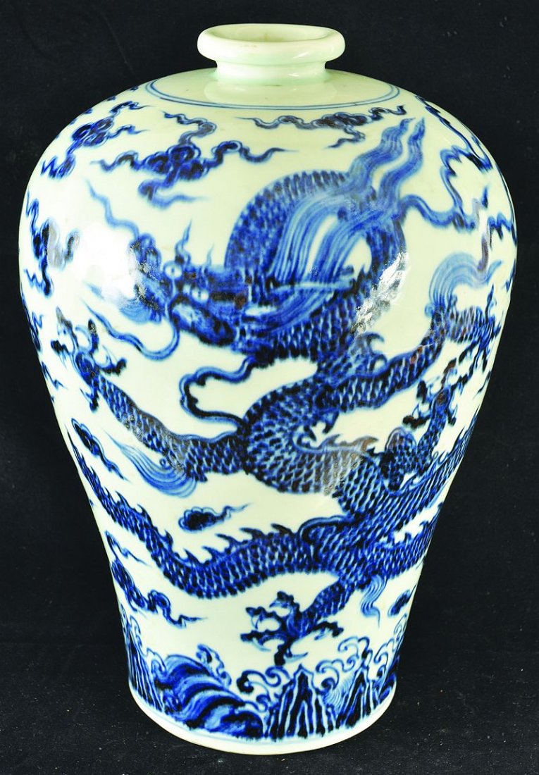 A LARGE CHINESE MING-STYLE BLUE & WHITE PORCELAIN VASE,: A LARGE CHINESE MING-STYLE BLUE & WHITE PORCELAIN VASE, the sides painted with a dragon & phoenix amidst cloud and flame scrolls, the base unglazed, 15.25in high. £300-500