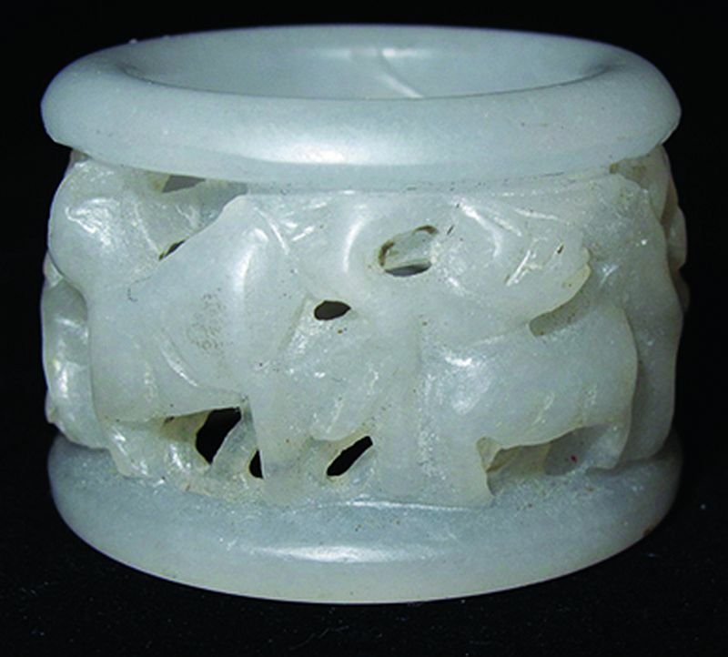 AN UNUSUAL CHINESE WHITE JADE PIERCED RING, the sides: AN UNUSUAL CHINESE WHITE JADE PIERCED RING, the sides carved with deer and foliage, 1.6in diameter. £80-120
