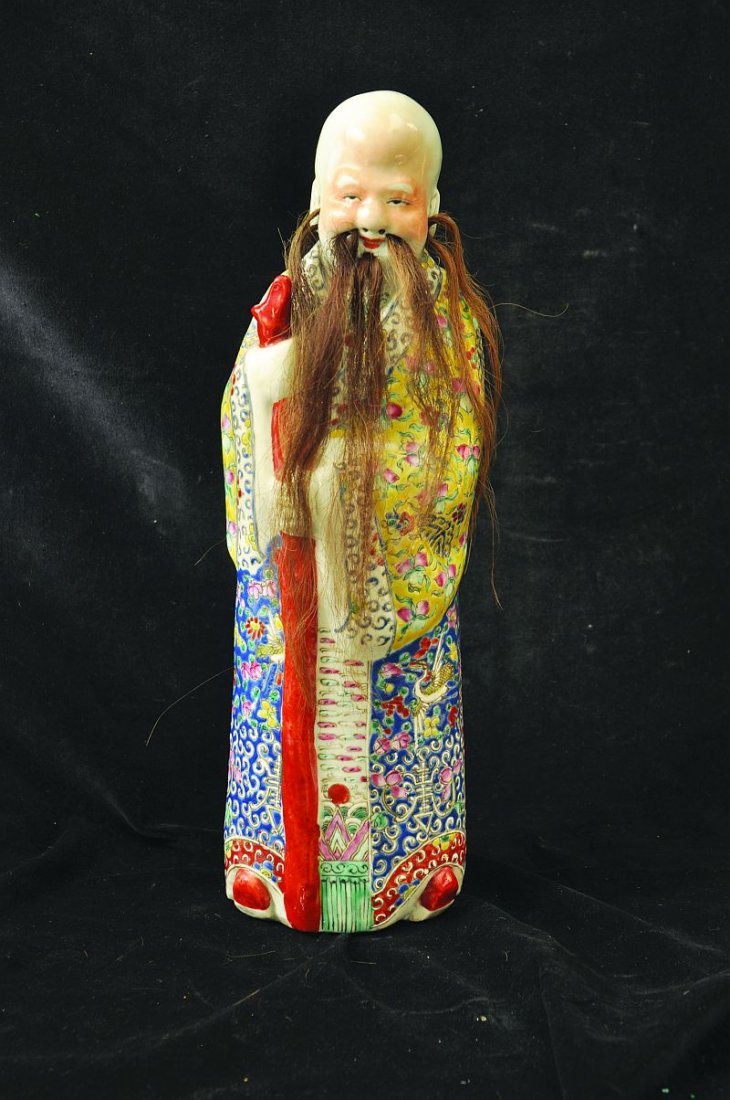 AN EARLY 20TH CENTURY CHINESE FAMILLE ROSE PORCELAIN: AN EARLY 20TH CENTURY CHINESE FAMILLE ROSE PORCELAIN FIGURE OF A SAGE, dressed in elaborately decorated robes, his face with original horse hair, the base unglazed, 13.4in high. £150-200
