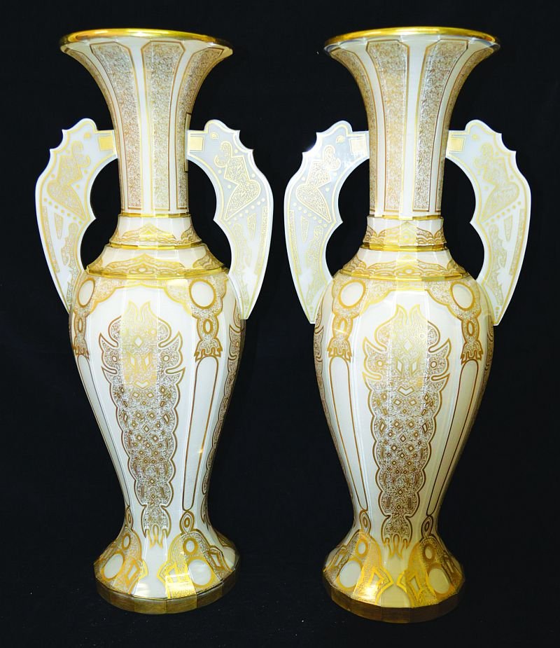 A SUPERB PAIR OF ROCKINGHAM WHITE OPAQUE TWO HANDLED: A SUPERB PAIR OF ROCKINGHAM WHITE OPAQUE TWO HANDLED VASES IN THE ALHAMBRA STYLE with rich gilt decoration. 20ins high. £2000-3000.