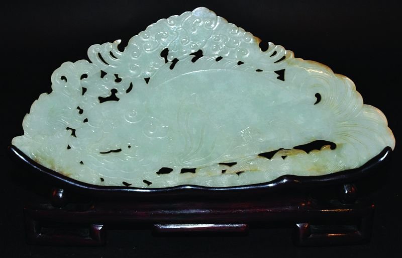 A GOOD 19TH/20TH CENTURY CHINESE JADE PLAQUE, together: A GOOD 19TH/20TH CENTURY CHINESE JADE PLAQUE, together with a wood display stand, the shaped and pierced plaque unusually carved in shallow relief with a Shachihoko dragon fish and its young above wav