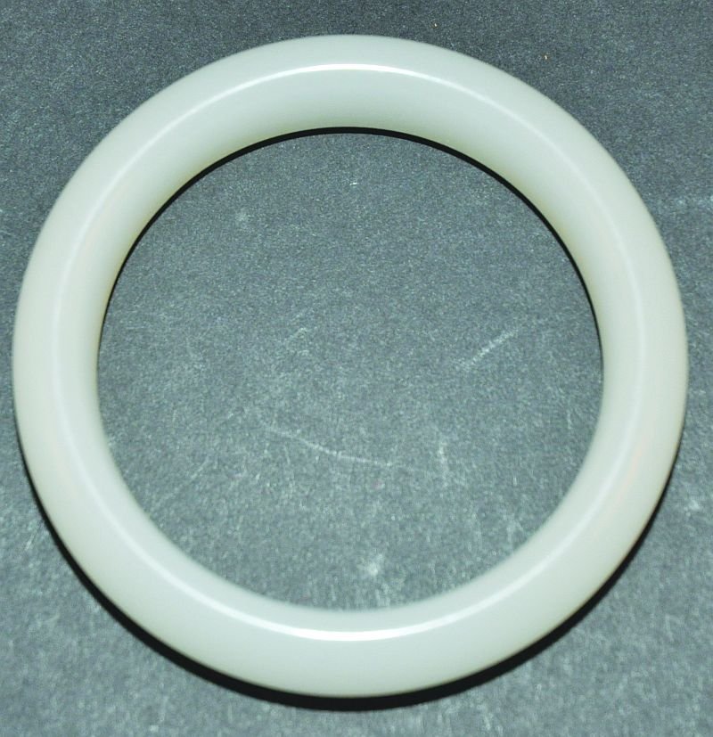 A CHINESE WHITE JADE BANGLE, 3.25in diameter, the inner: A CHINESE WHITE JADE BANGLE, 3.25in diameter, the inner rim 2.4in diameter. £70-100