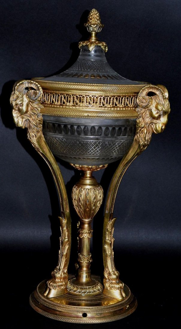 A SUPERB 19TH CENTURY FRENCH ORMOLU MOUNTED FROSTED AND: A SUPERB 19TH CENTURY FRENCH ORMOLU MOUNTED FROSTED AND CUT GLASS PERFUMIERE AND COVER with pineapple finial, rams masks on hoof feet with circular base. 20ins high. £500-600.