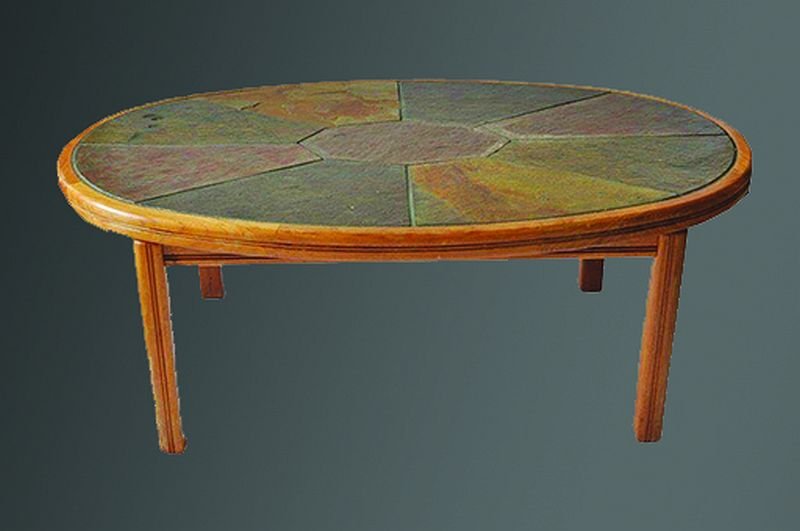 HASLEV (DANISH) AN OVAL OAK FRAMED COFFEE TABLE, the: HASLEV (DANISH) AN OVAL OAK FRAMED COFFEE TABLE, the top inset with natural stone, applied label to the underside. 3ft 7ins x 2ft 3ins. £400-500.