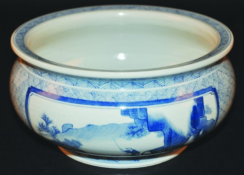 A CHINESE BLUE & WHITE PORCELAIN BOMBE PORCELAIN: A CHINESE BLUE & WHITE PORCELAIN BOMBE PORCELAIN CENSER, the sides painted with two river landscape panels reserved on a trellis ground embellished with Shou symbols, 9in diameter at rim. £200-300
