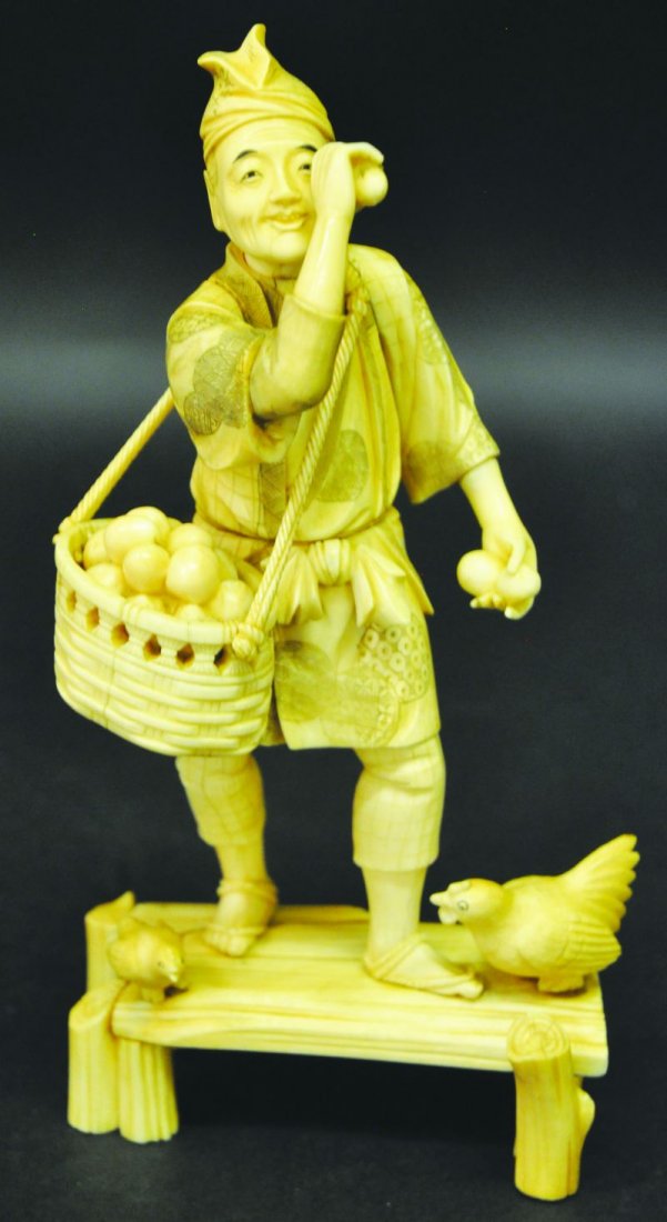 A JAPANESE SIGNED IVORY FIGURE OF A FARMER, standing on: A JAPANESE SIGNED IVORY FIGURE OF A FARMER, standing on a wood grained platform in the company of a hen and chick, a basket slung over his shoulder, 9.75in high. £300-400