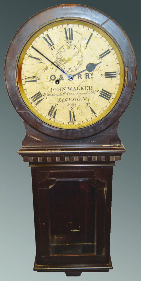 AN UNUSUAL 19TH CENTURY RAILWAY WALL CLOCK with 8 day: AN UNUSUAL 19TH CENTURY RAILWAY WALL CLOCK with 8 day movement, engraved painted brass dial, signed by John Walker, 68 Cornhill and 230 Regent Street, London. 4ft 0ins high. £1200-1500.