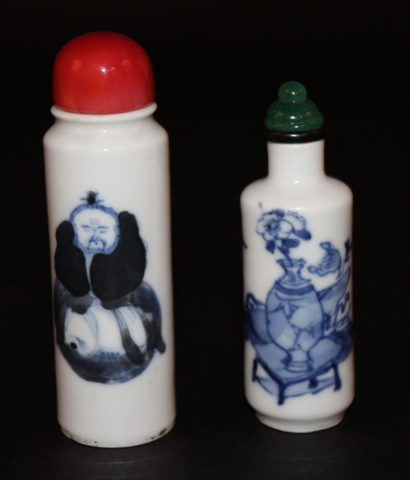 TWO CHINESE BLUE & WHITE PORCELAIN SNUFF BOTTLES WITH: TWO CHINESE BLUE & WHITE PORCELAIN SNUFF BOTTLES WITH STOPPERS, one painted with a sage and calligraphy, the other with precious objects, 3.8in & 3.3in high overall. (2) £70-100.