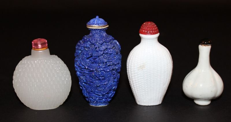 A CHINESE WHITE-GLAZED PORCELAIN SNUFF BOTTLE &: A CHINESE WHITE-GLAZED PORCELAIN SNUFF BOTTLE & STOPPER, of fluted pear form, 2.3in high; together with three moulded snuff bottles, 3.25in high & smaller. (4) £40-60.