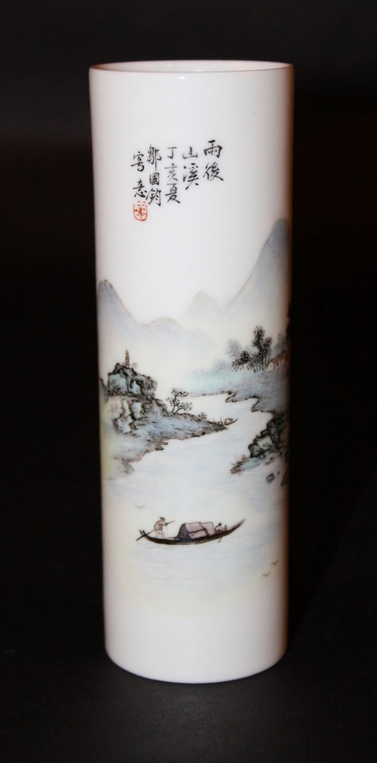 A SLENDER CHINESE PORCELAIN BRUSH POT, the sides of the: A SLENDER CHINESE PORCELAIN BRUSH POT, the sides of the cylindrical body painted with a river landscape scene and columns of calligraphy, the base with a seal mark, 5.9in high. £70-100.
