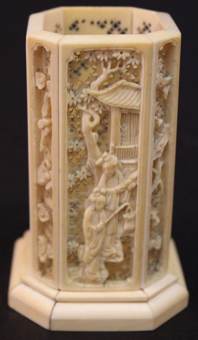 A SMALL 19TH CENTURY CHINESE SECTIONAL CANTON IVORY: A SMALL 19TH CENTURY CHINESE SECTIONAL CANTON IVORY BRUSHPOT, of chamfered square section, the sides carved and pierced with figural scenes reserved on trellis grounds, 3.7in high. £100-150.