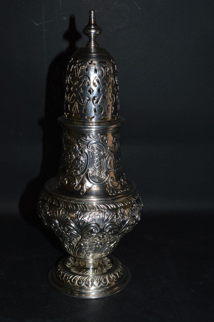A VERY GOOD LARGE VICTORIAN SUGAR CASTER with repousse: A VERY GOOD LARGE VICTORIAN SUGAR CASTER with repousse decoration. 11ins high. London 1896. Maker: Charles Stuart Hall. £350-400.