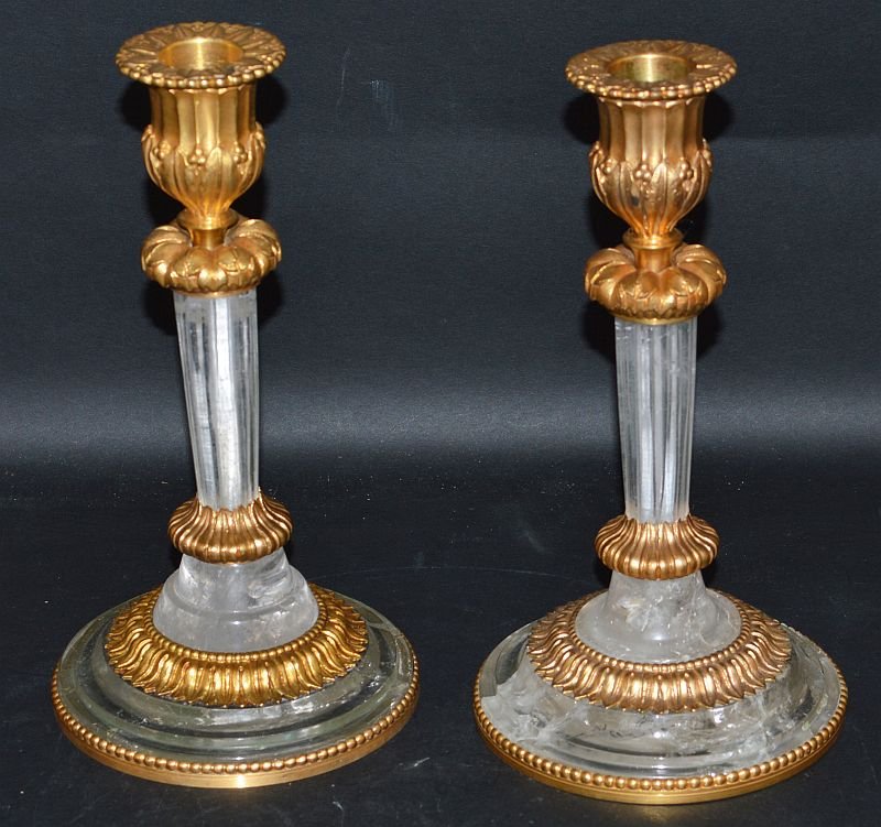 A VERY GOOD PAIR OF LOUIS XVI DESIGN ROCK CRYSTAL AND: A VERY GOOD PAIR OF LOUIS XVI DESIGN ROCK CRYSTAL AND ORMOLU FOUR LIGHT CANDLESTICKS on circular bases. 7ins high. £250-300.