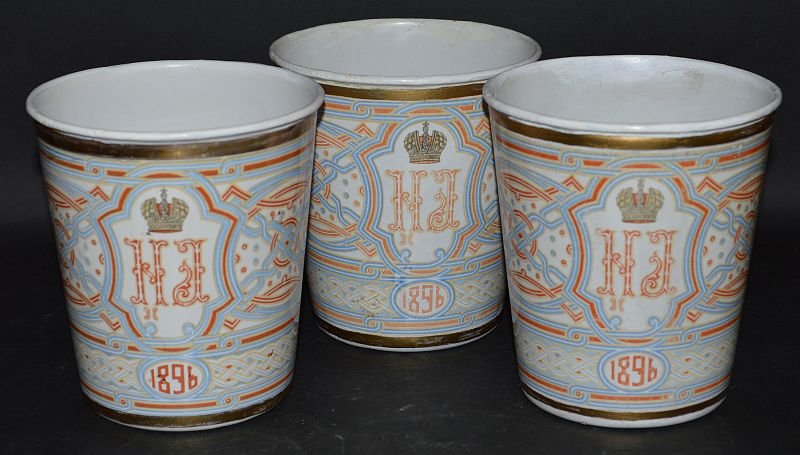 A SET OF THREE RUSSIAN ENAMEL CORONATION BEAKERS to: A SET OF THREE RUSSIAN ENAMEL CORONATION BEAKERS to commemorate the marriage of NICHOLAS II and ALEXANDRA, dated 1896. £50-100 .