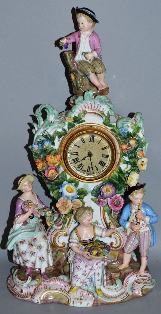 A VERY GOOD 19TH CENTURY GERMAN PORCELAIN MANTLE CLOCK: A VERY GOOD 19TH CENTURY GERMAN PORCELAIN MANTLE CLOCK encrusted with flowers and painted cupids. 14ins high.