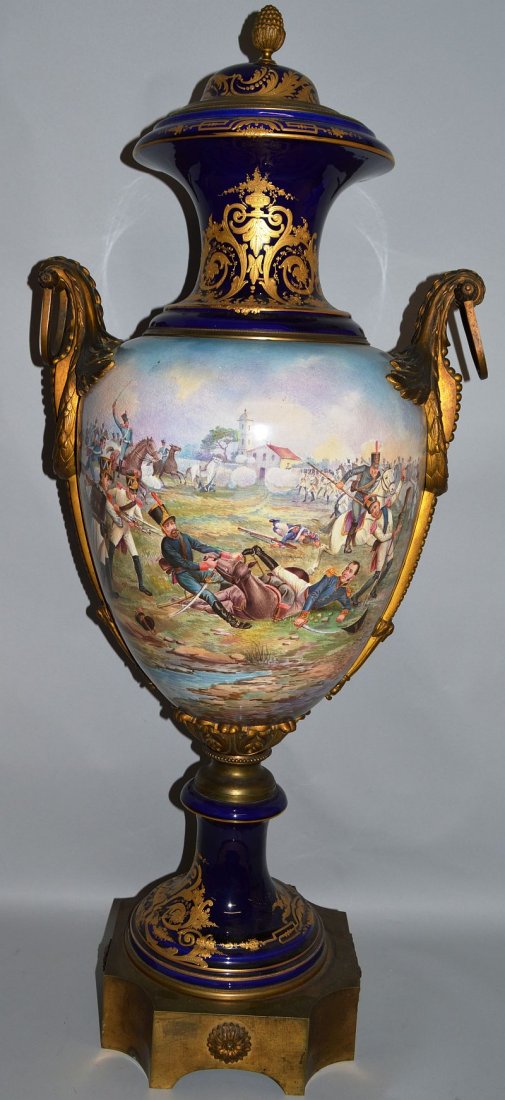 A GOOD LARGE 19TH CENTURY FRENCH SEVRES TWO HANDLED: A GOOD LARGE 19TH CENTURY FRENCH SEVRES TWO HANDLED VASE AND COVER with ormolu mounts, the body painted with a portrait of NAPOLEON, the reverse a BATTLE SCENE. 39ins high.