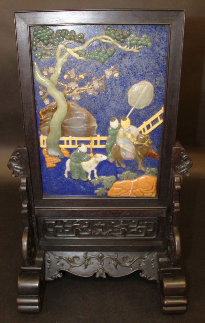 A GOOD QUALITY HARDSTONE ONLAID LAPIZ TYPE TABLE: A GOOD QUALITY HARDSTONE ONLAID LAPIZ TYPE TABLE SCREEN, in a Zitan-type wood frame and detachable stand, decorated to one side with boys and goats in a garden setting, the reverse with columns of cal