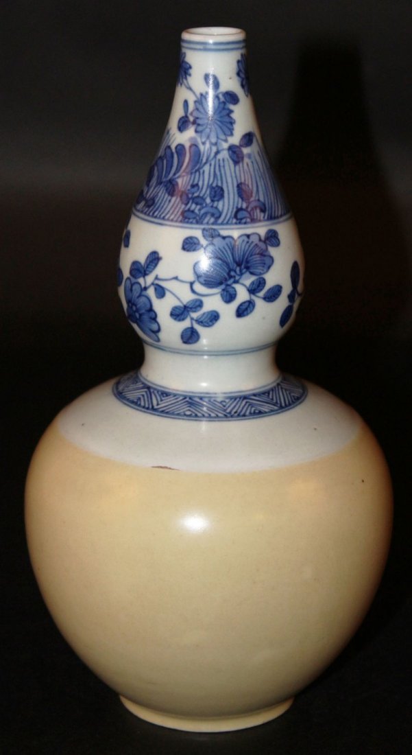 A CHINESE BLUE & WHITE & CAFE-AU-LAIT DOUBLE-GOURD: A CHINESE BLUE & WHITE & CAFE-AU-LAIT DOUBLE-GOURD PORCELAIN VASE, the base with a ‘shop’ mark, 8.5in high.
