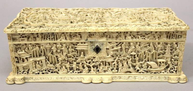 A FINE QUALITY 19TH CENTURY CHINESE CANTON IVORY: A FINE QUALITY 19TH CENTURY CHINESE CANTON IVORY CASKET, with hinged cover, the shaped top and sides elaborately carved in deep relief with a profusion of figures in elaborate pagoda, terrace and boat