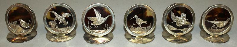 A SUPERB SET OF SIX SILVER AND TORTOISESHELL â€˜GAME: A SUPERB SET OF SIX SILVER AND TORTOISESHELL â€˜GAME BIRDSâ€™ MENU HOLDERS. Birmingham 1913. Maker Mappin & Webb. In original box.