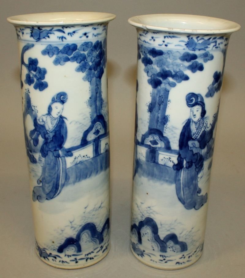 A PAIR OF 19TH CENTURY CHINESE BLUE & WHITE PORCELAIN: A PAIR OF 19TH CENTURY CHINESE BLUE & WHITE PORCELAIN SLEEVE VASES, painted with ladies in garden settings, each base with a four-character Kangxi mark, 10.25in high. £200-300