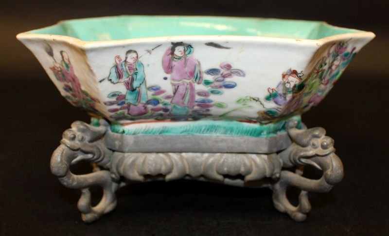 A TONGZHI MARK & PERIOD CHINESE FAMILLE ROSE SHAPED: A TONGZHI MARK & PERIOD CHINESE FAMILLE ROSE SHAPED PORCELAIN BOWL, circa 1870, together with an unusual fitted pewter stand, the sides of the bowl painted with a continuous scene of mandarins, warrio