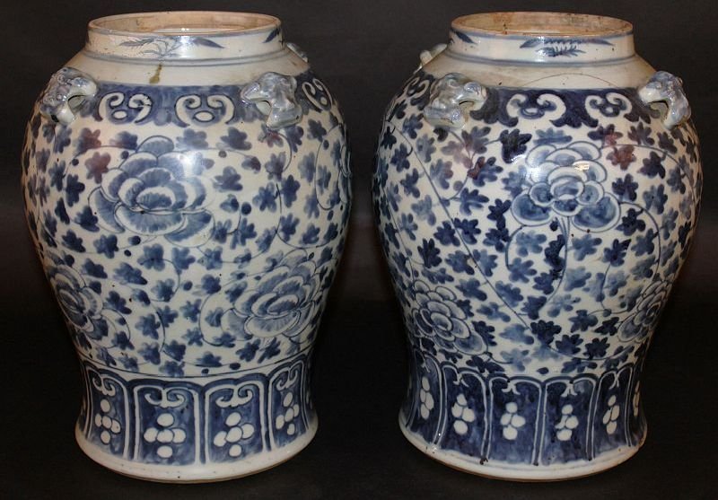 A PAIR OF 19TH CENTURY CHINESE BLUE & WHITE PORCELAIN: A PAIR OF 19TH CENTURY CHINESE BLUE & WHITE PORCELAIN JARS, each painted with a formal design of leaf and scroll stemmed peony, 11.6in high.