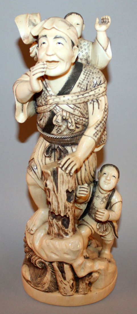 A LARGE GOOD QUALITY EARLY 20TH CENTURY SIGNED JAPANESE: A LARGE GOOD QUALITY EARLY 20TH CENTURY SIGNED JAPANESE CARVED IVORY FIGURE OF A MAN & TWO BOYS, the man standing on a rocky plinth above waves and leaning forward on a tree stump, one boy by his side