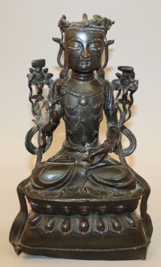 A CHINESE MING DYNASTY BRONZE FIGURE OF BUDDHA,: A CHINESE MING DYNASTY BRONZE FIGURE OF BUDDHA, 16th/17th Century, seated in meditation on a double lotus base, the hem of his robe with engraved floral decoration, 10.2in high.