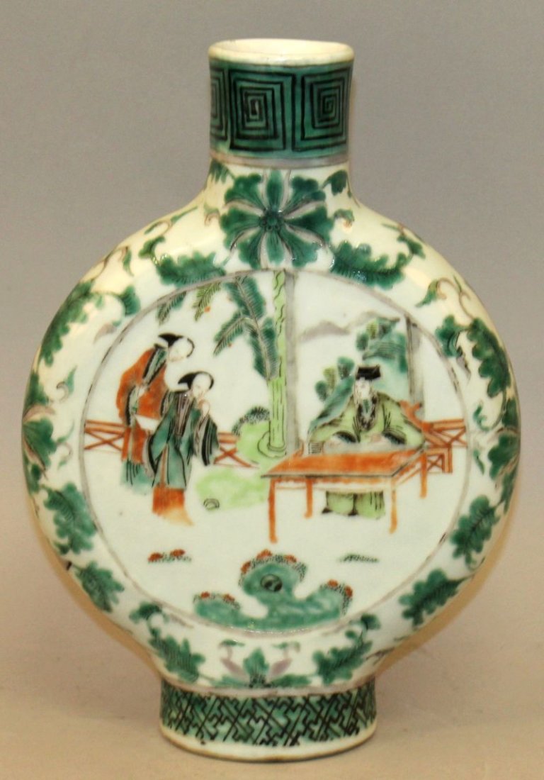 A 19TH CENTURY CHINESE FAMILLE VERTE PORCELAIN MOON: A 19TH CENTURY CHINESE FAMILLE VERTE PORCELAIN MOON FLASK, painted with figural fenced garden scenes, 10.25in high.