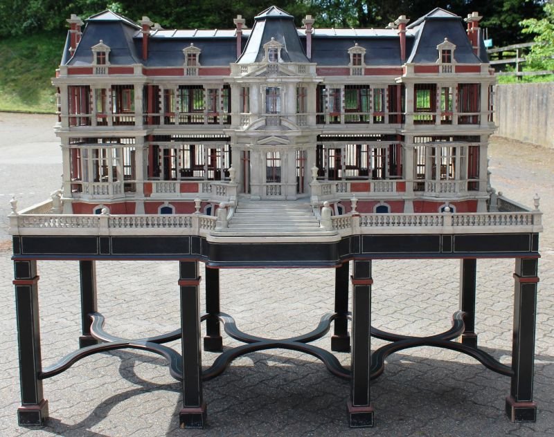 A MONUMENTAL NORTH EUROPEAN POLYCHROME-DECORATED BIRD: A MONUMENTAL NORTH EUROPEAN POLYCHROME-DECORATED BIRD CAGE, 19TH CENTURY, in the form of a 17th century mansion of H-shaped outline with central projecting bay, Mansard roof with pedimented dormer win