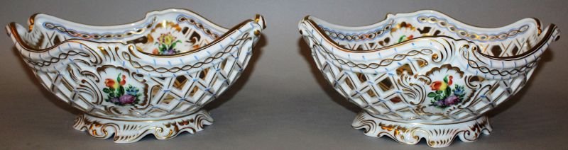 A GOOD PAIR OF HERAND HAND PAINTED PIERCED TWO HANDLED: A GOOD PAIR OF HERAND HAND PAINTED PIERCED TWO HANDLED BASKETS painted with flowers. 10.5ins wide.