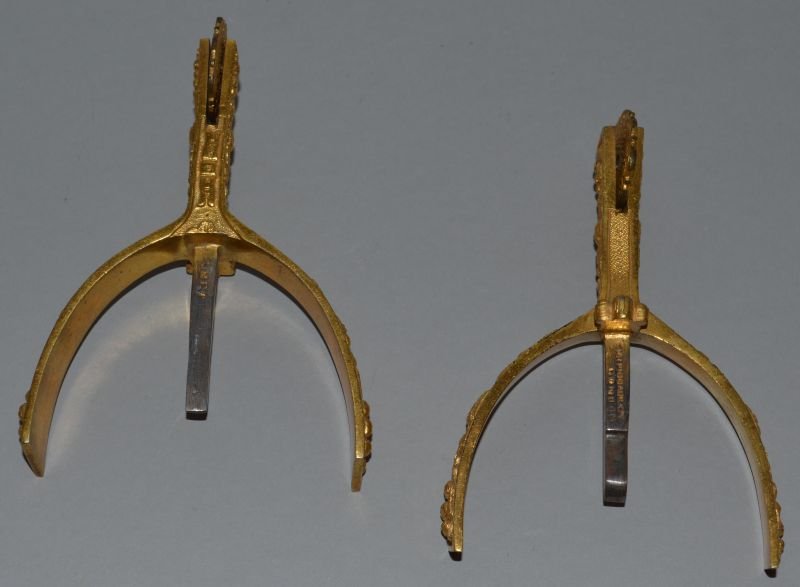 A PAIR OF LEFT AND RIGHT GILT BRASS BRITISH MILITARY: A PAIR OF LEFT AND RIGHT GILT BRASS BRITISH MILITARY SPURS decorated with crowns, acorns and oak leaves. Stamped MAXWELL (for HENRY MAXWELL), 161 PICCADILLY, CIRCA. 1920 4ins long.