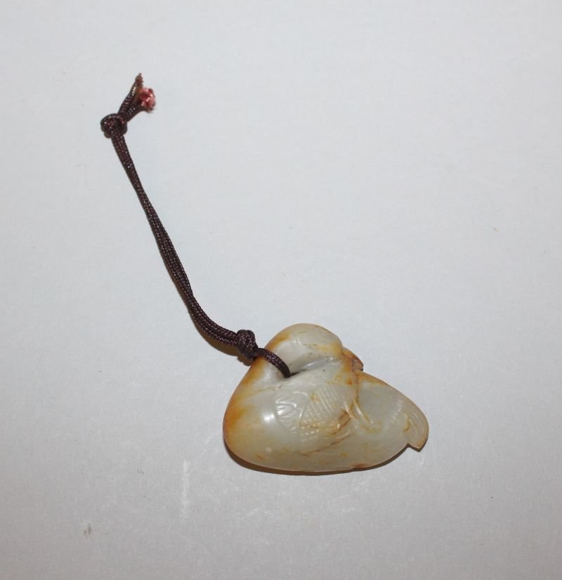 A CHINESE JADE-LIKE CARVING OF A WATER BIRD, its head (1 of 3)