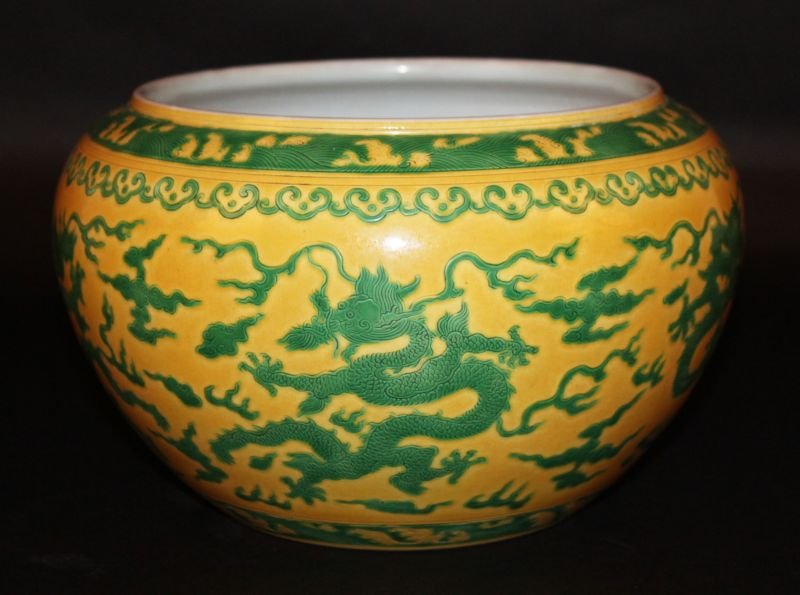 A CHINESE YELLOW-GROUND GREEN-ENAMELLED DRAGON BOWL, (1 of 3)